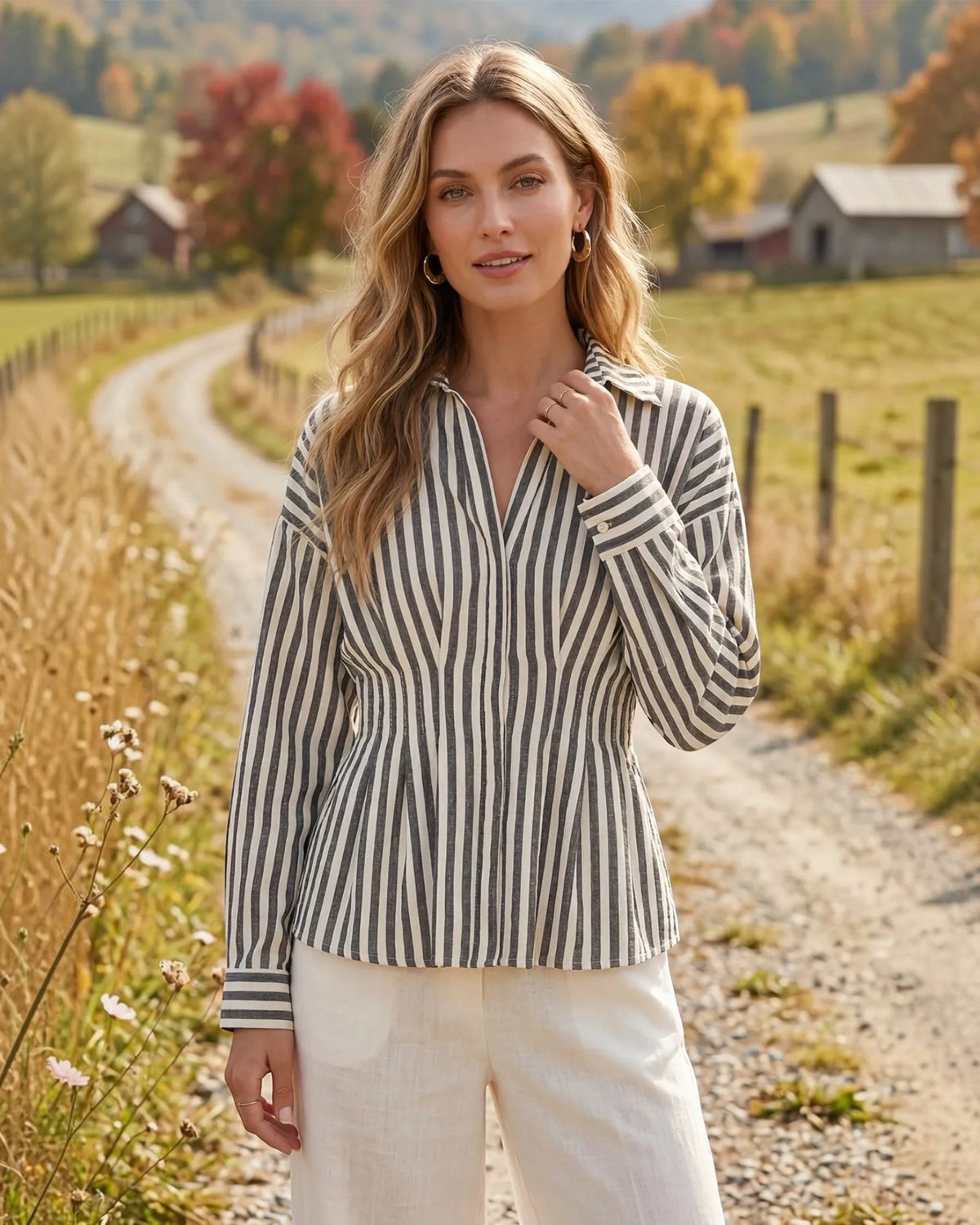 Model wearing a charcoal and ivory button up long sleeve top with front waist pintucks and matching ivory pants. 