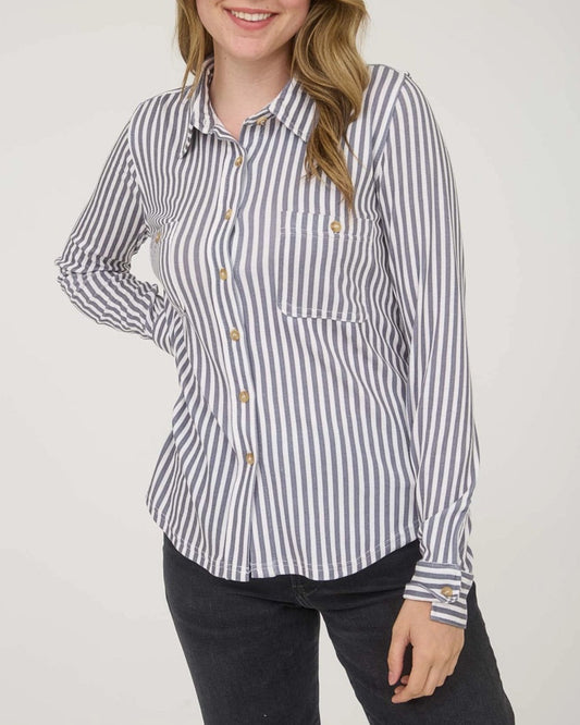 Woman wearing a striped shirt with a plain background.