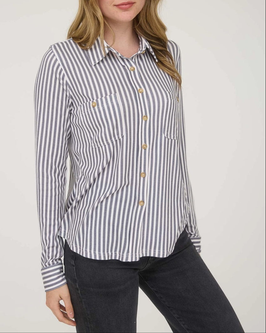 Woman wearing a striped shirt against a plain background.