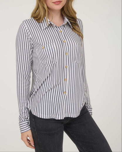 Woman wearing a striped shirt against a plain background.