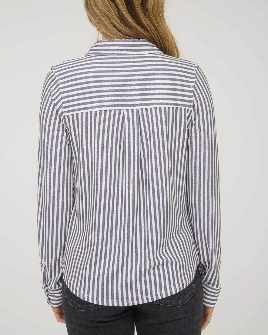 Person wearing a black and white striped shirt against a plain background.