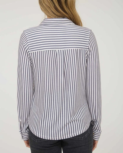Person wearing a black and white striped shirt against a plain background.