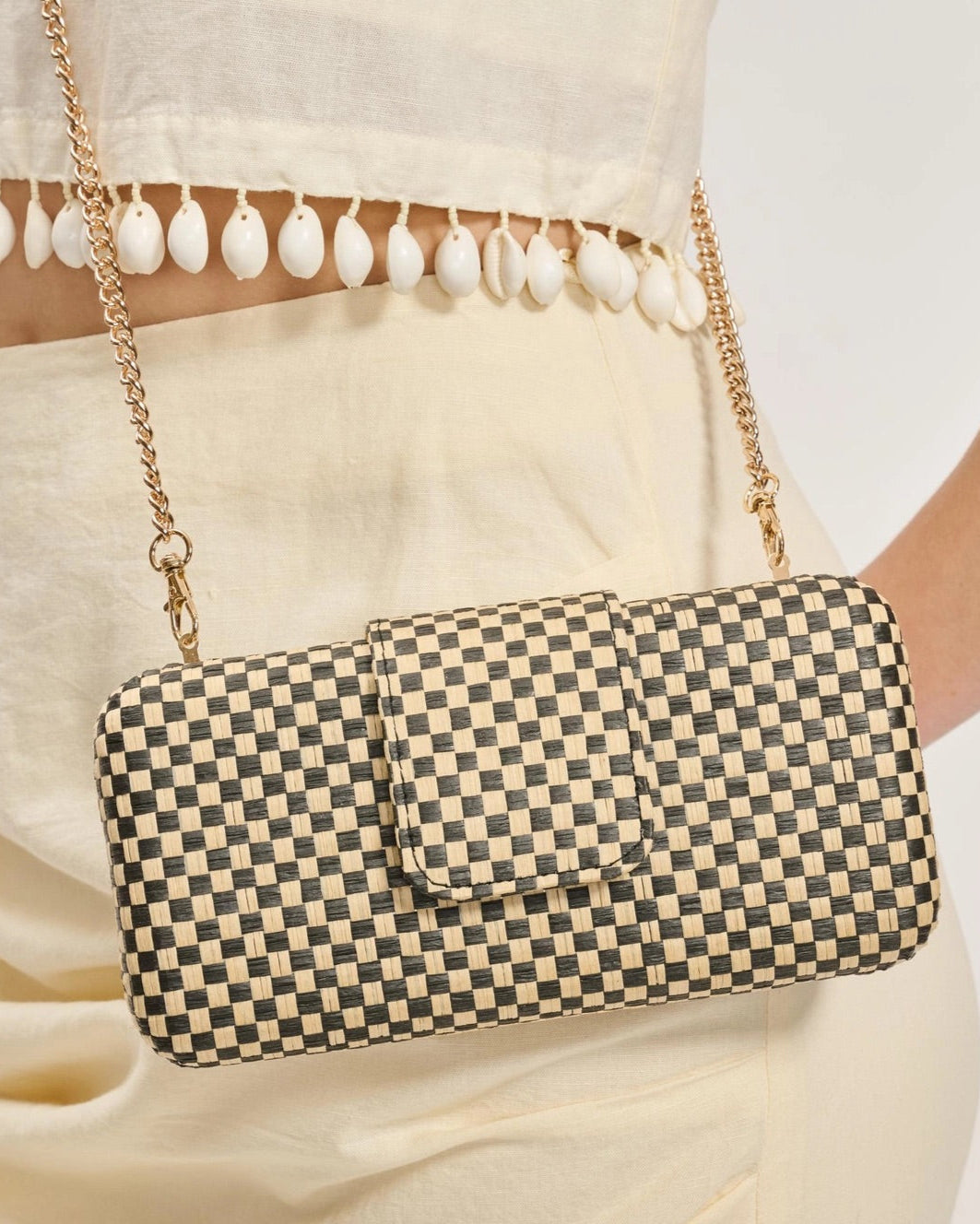 Black and Natural Checkered crossbody bag with chain strap.