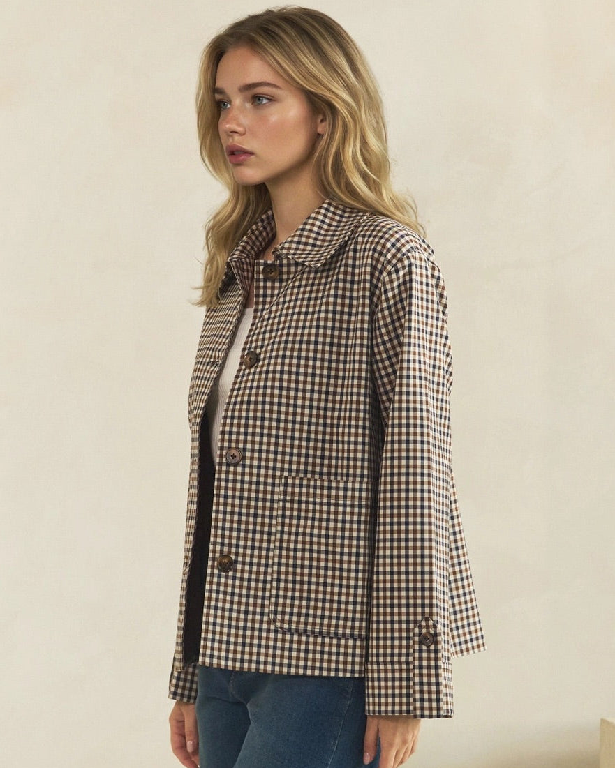 Angled view of brown and cream check jacket showing its relaxed fit, patch pocket, and button-tab cuff.