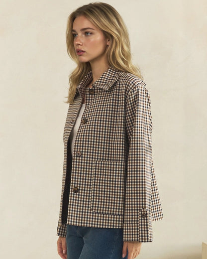 Angled view of brown and cream check jacket showing its relaxed fit, patch pocket, and button-tab cuff.