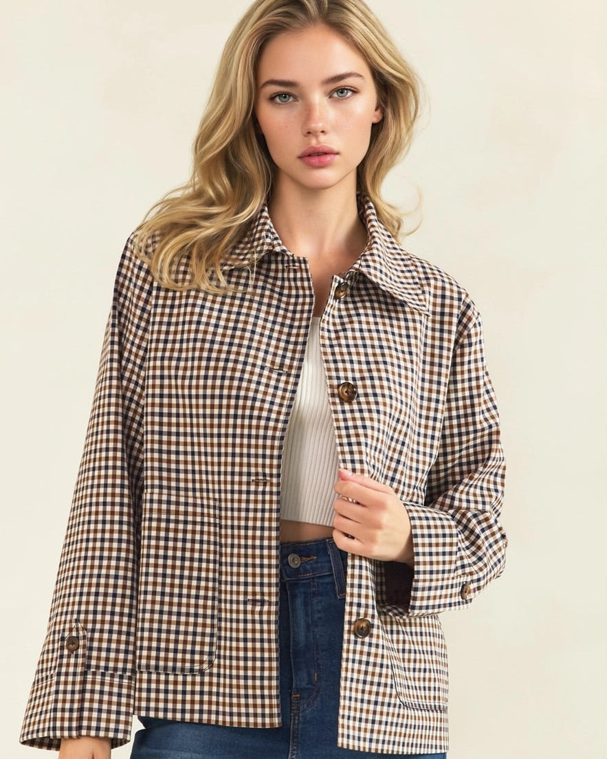 Model wearing a brown and cream check jacket with a pointed collar, button front, and large patch pockets.