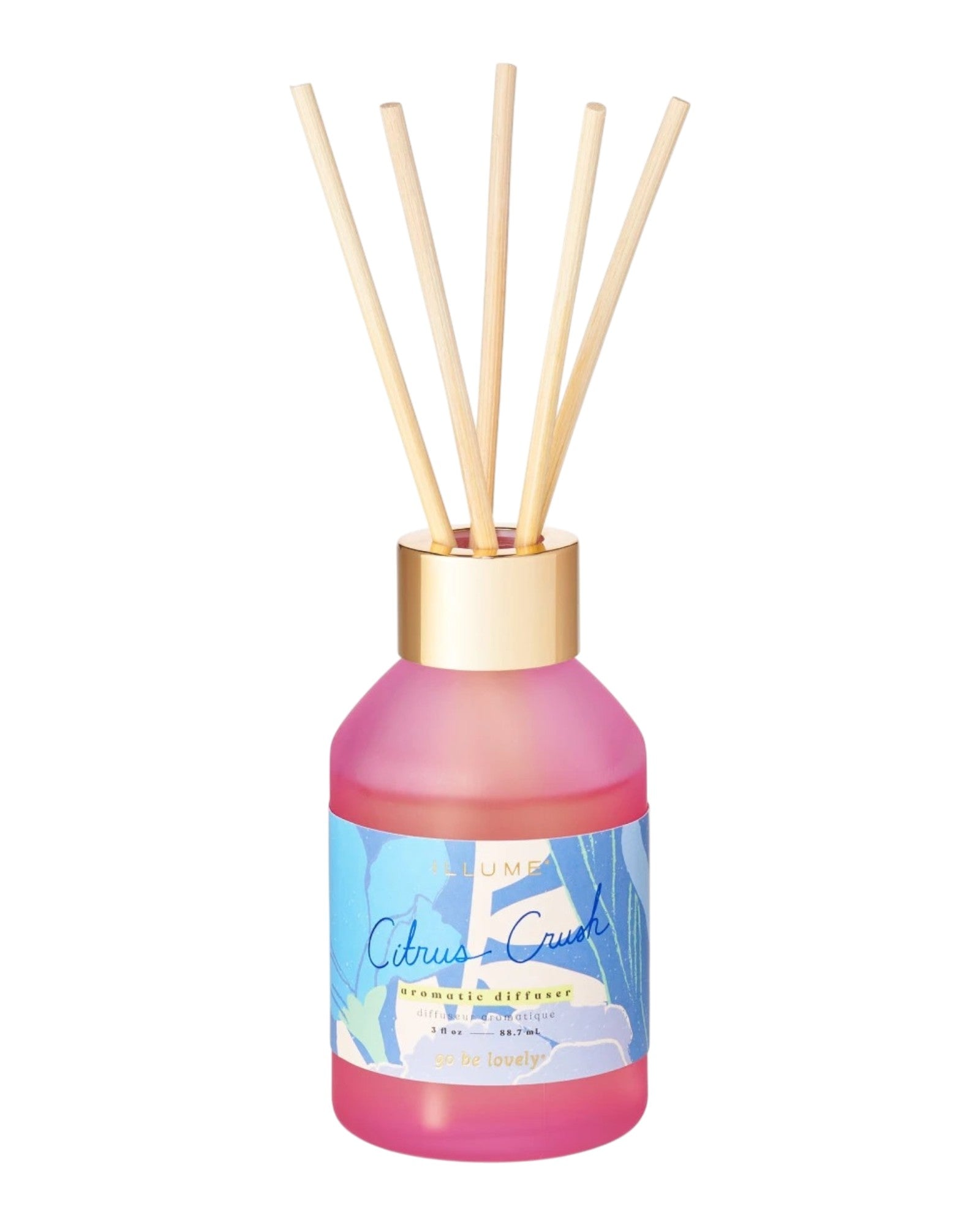 Pink diffuser bottle with wooden sticks on a white background.