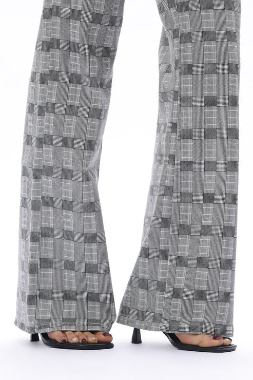 Close up of charcoal and gray denim plaid jeans shown from the knee down.