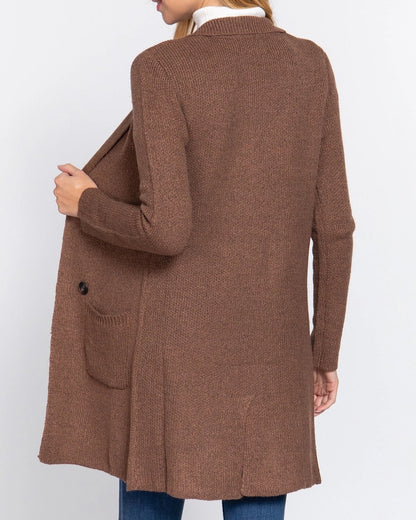 Woman wearing a brown cardigan on a white background.