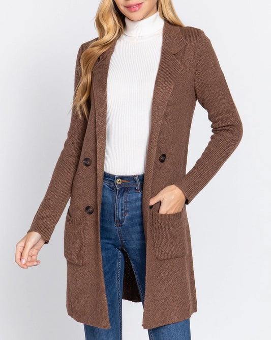 Woman wearing a cocoa brown longline sweater jacket with notched collar and buttons.