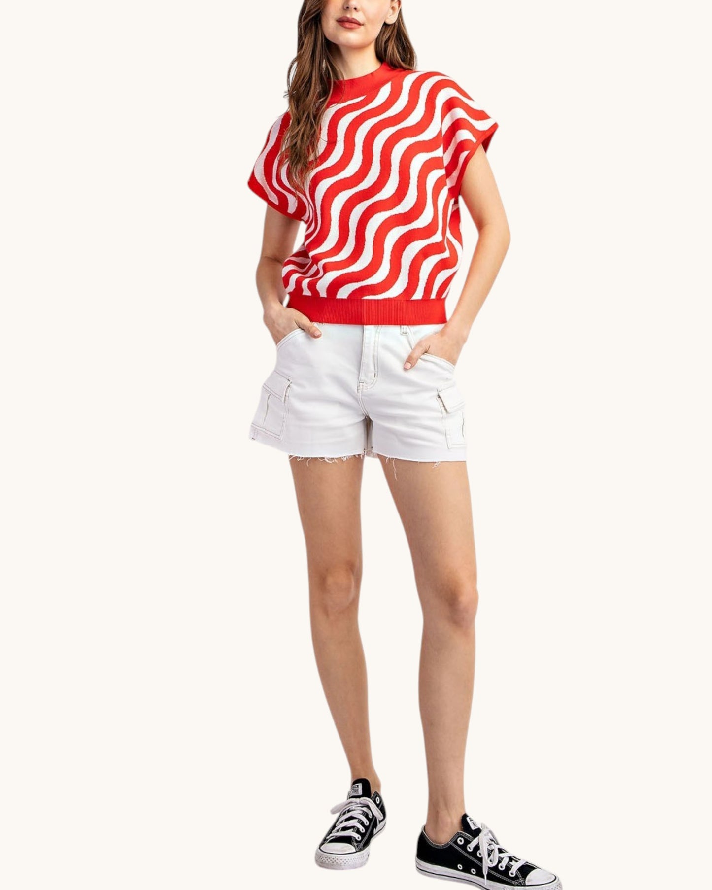 Cherry red and white swirl short sleeve summer sweater worn with white shorts and black sneakers, full length front view.