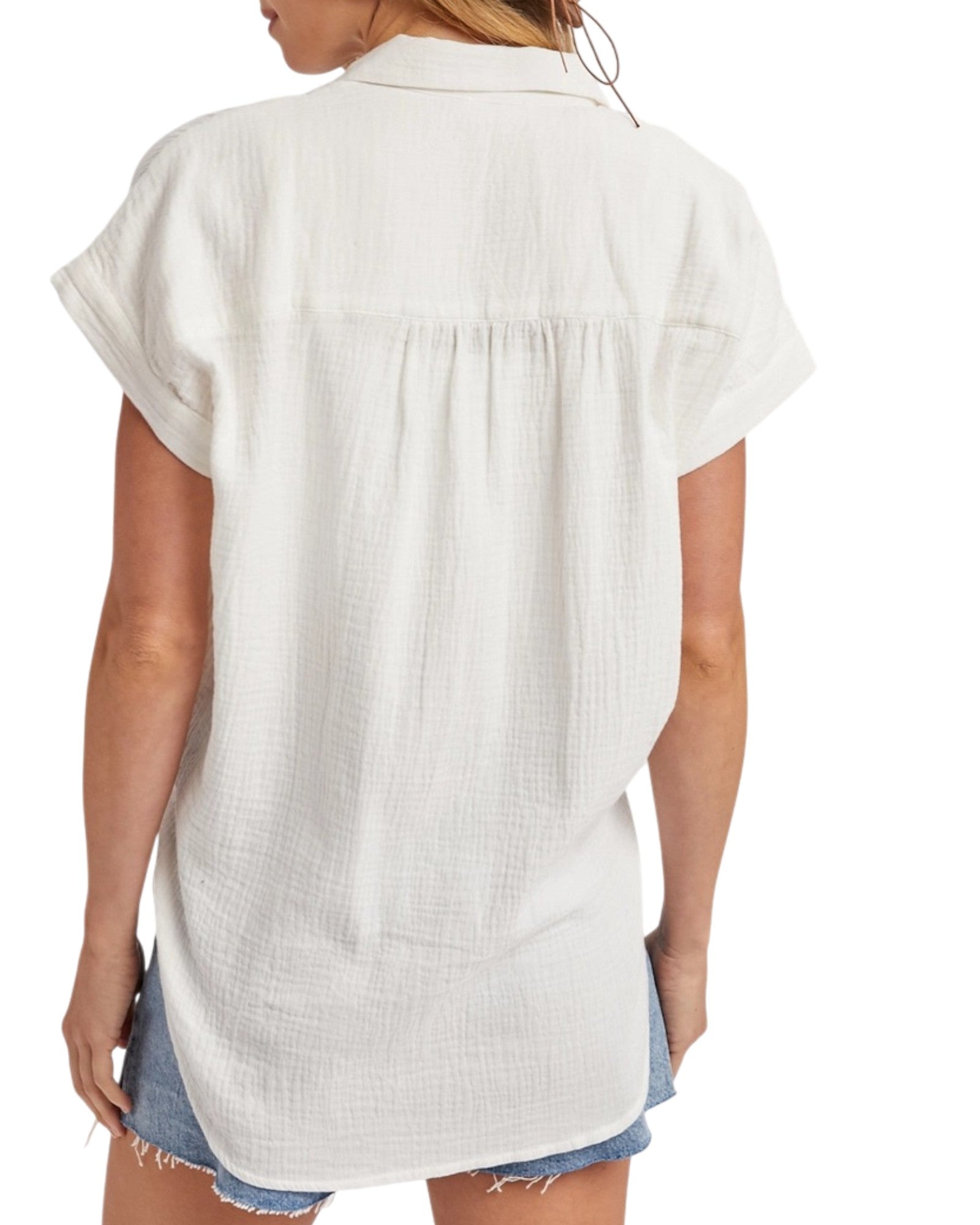 White sleeveless shirt worn by a person on a white background.