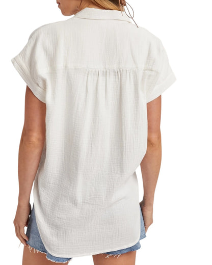 White sleeveless shirt worn by a person on a white background.