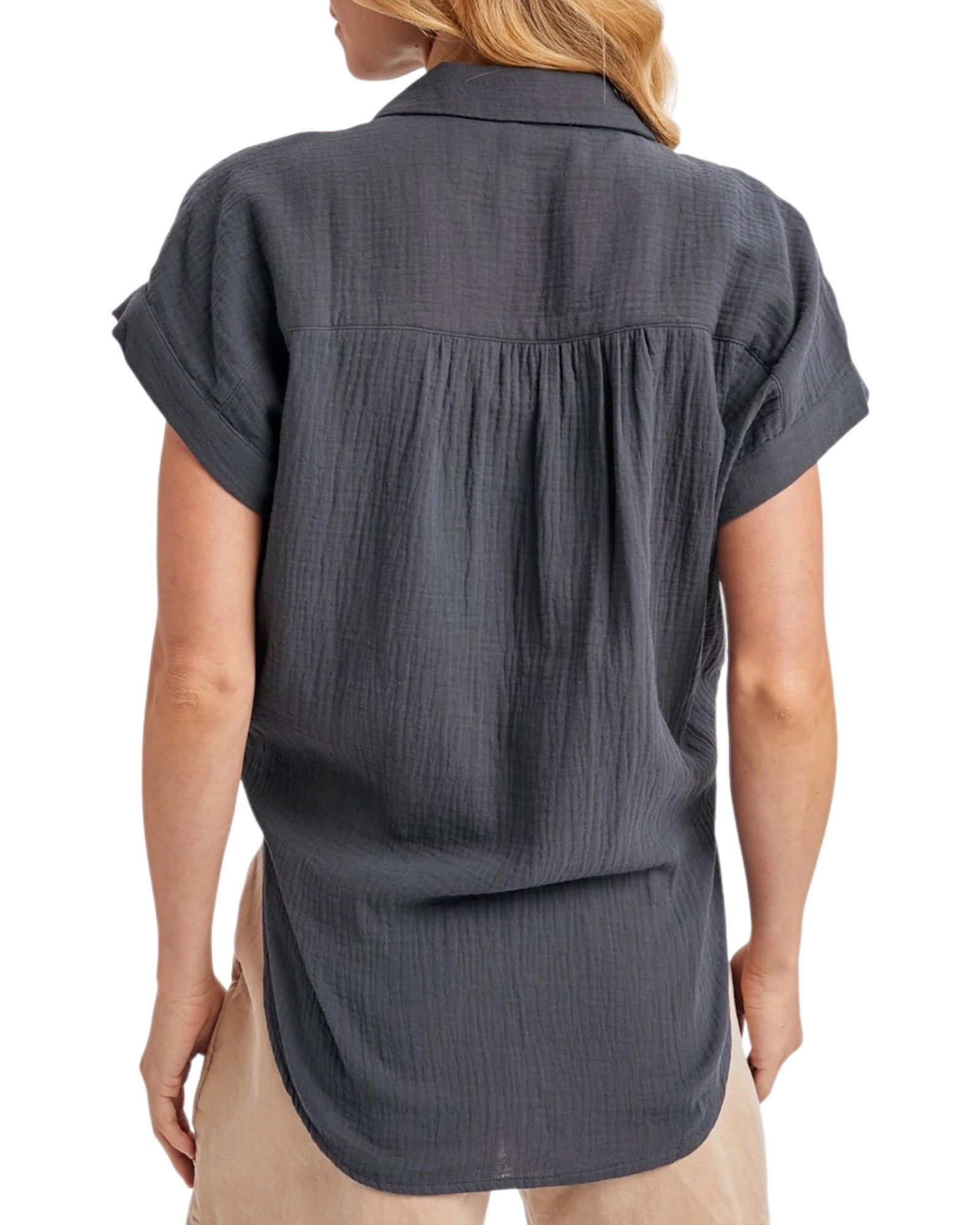 Dark gray short-sleeve shirt worn by a person on a white background.