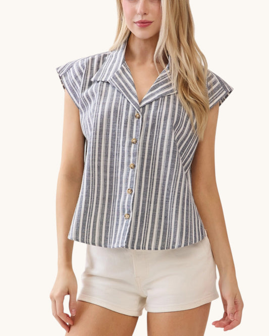 Woman wearing a striped shirt and white shorts on a white background