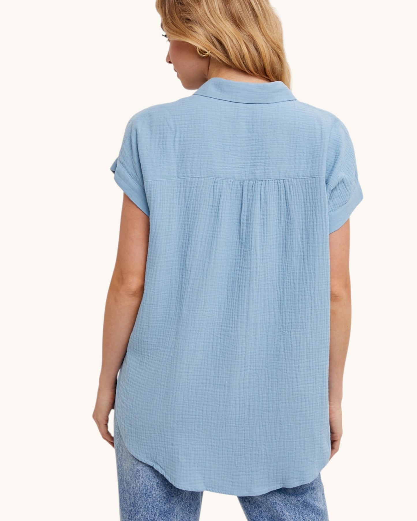 Light blue cotton shirt worn by a person on a white background