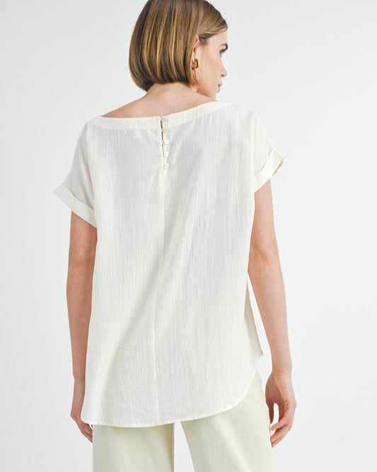 Cream button back dolman sleeve top with relaxed fit.