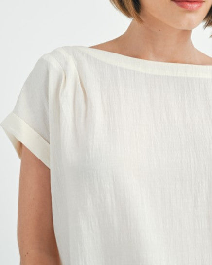 Cream button back dolman sleeve top with relaxed fit.