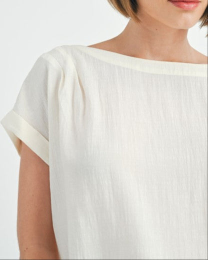 Cream button back dolman sleeve top with relaxed fit.