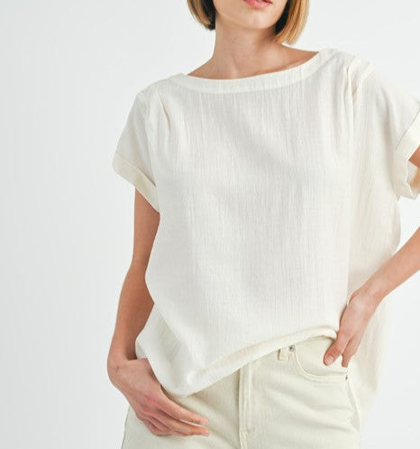 Cream button back dolman sleeve top with relaxed fit.