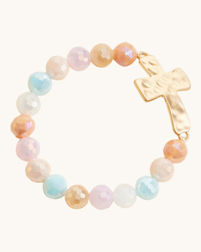 Hammered Gold Cross Glass Bead Stretch Bracelet in multi-color light beads, featuring large glass beads and hammered gold cross charm.