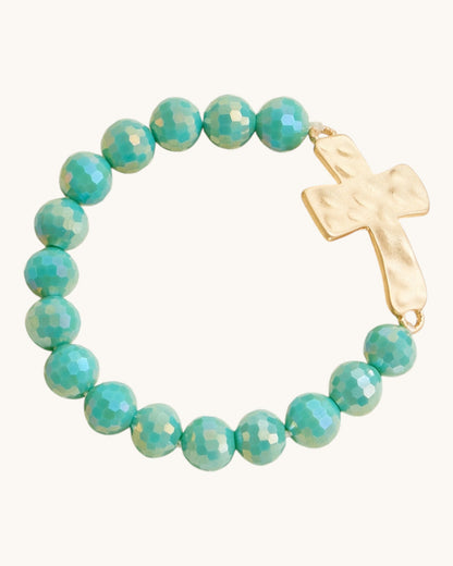 Hammered Gold Cross Glass Bead Stretch Bracelet in Teal, featuring large glass beads and hammered gold cross charm.