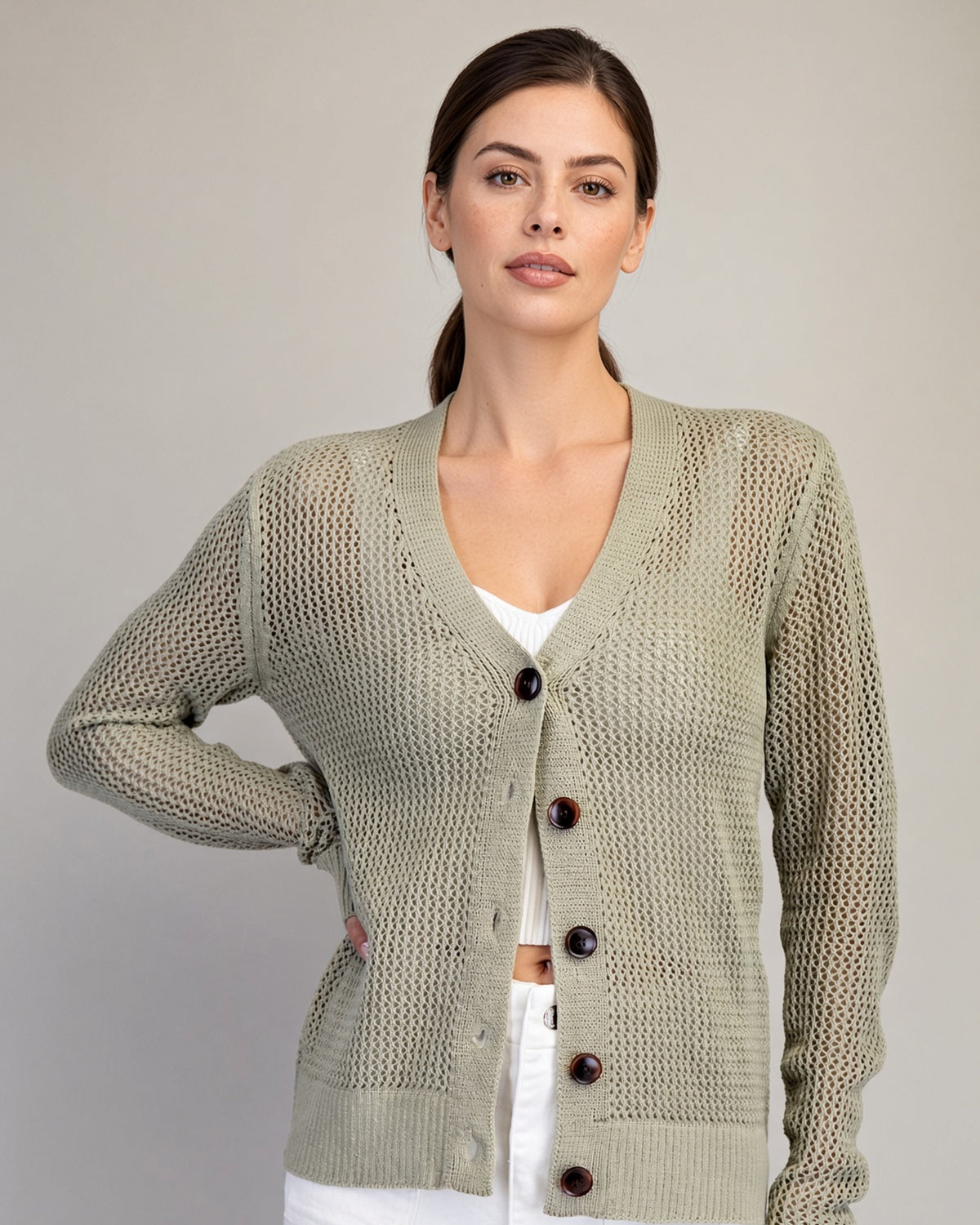 Dry Herb open-knit cardigan on model, showing button front and wide ribbed cuffs.