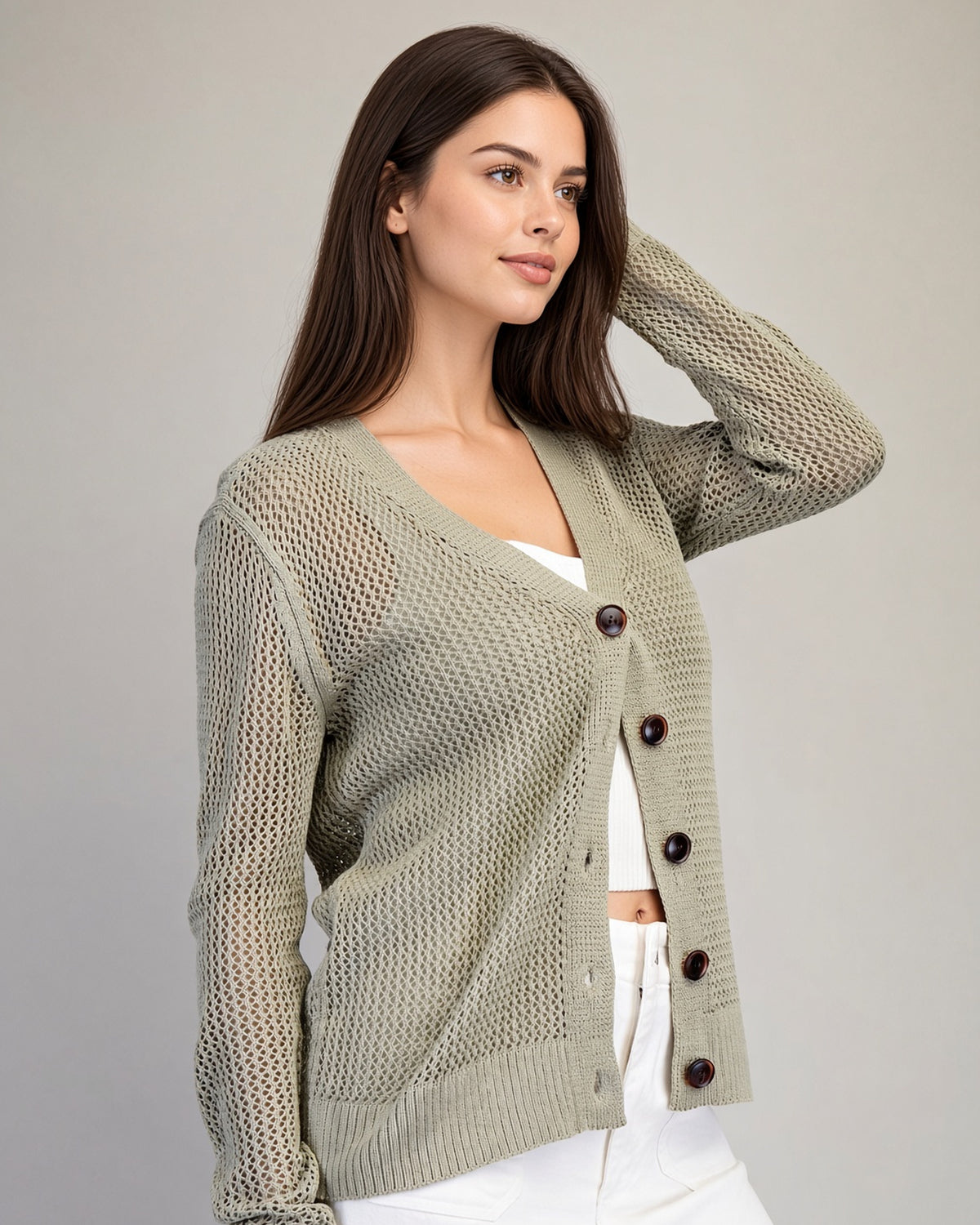 Side view of Dry Herb cardigan showing sheer open-knit texture, long sleeves, and ribbed hem.