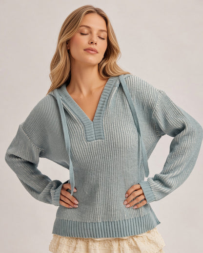 Front view of a model wearing the Chill Factor dusty teal sweater hoodie with a V-neck, drawstrings, and ribbed trim.