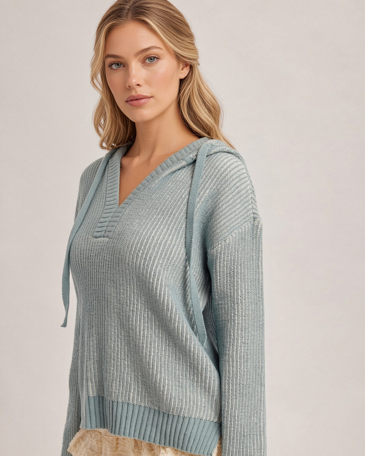 Angled view of the Chill Factor dusty teal sweater hoodie, showing the textured knit, dropped shoulders, and drawstrings.