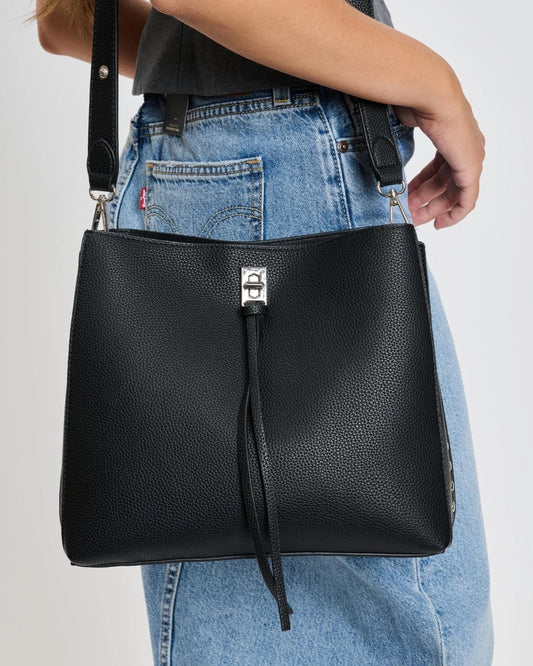 Eliza tassel vegan leather crossbody handbag with studs and turn lock in Almond or Black.