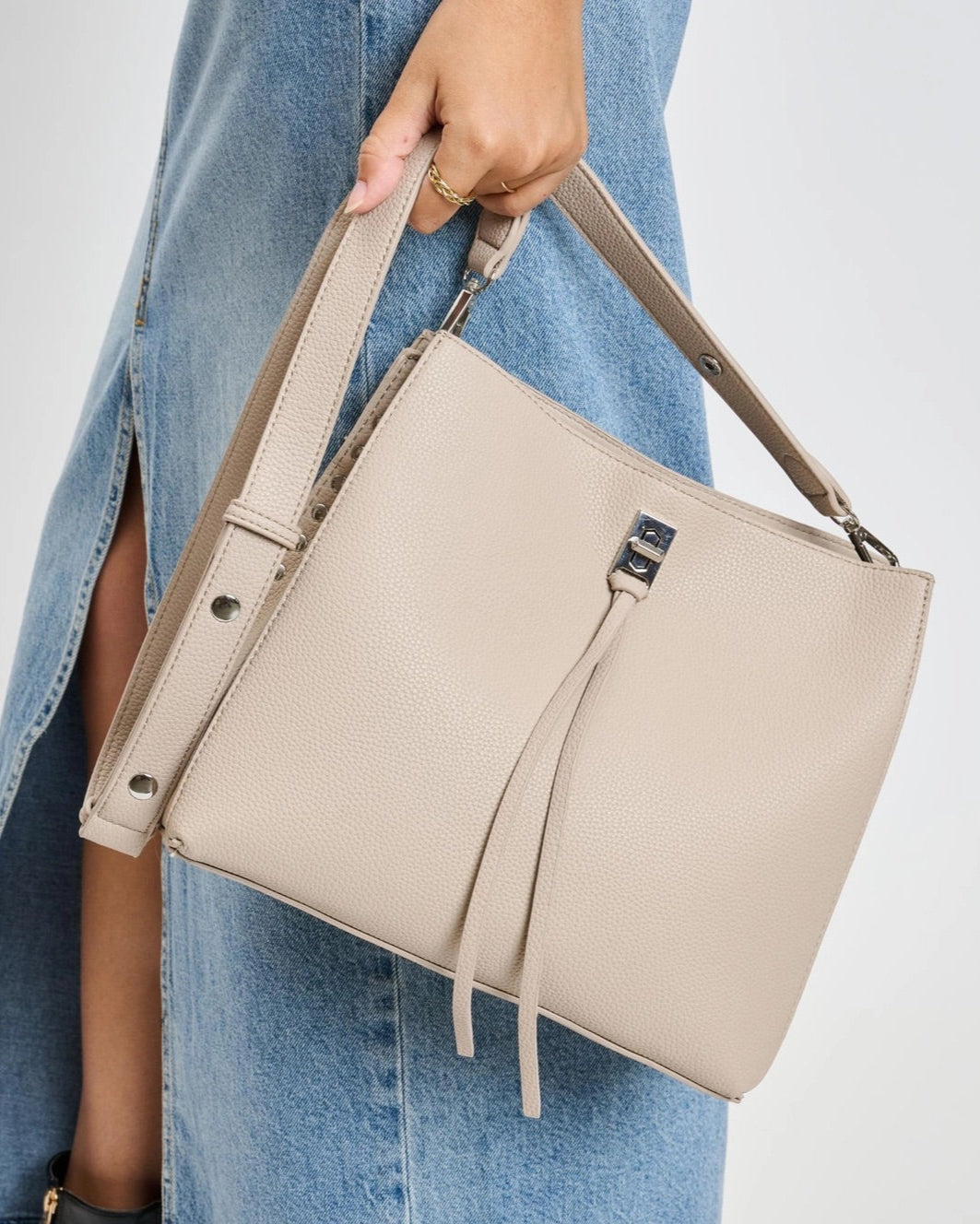 Eliza tassel vegan leather crossbody handbag with studs and turn lock in Almond or Black.