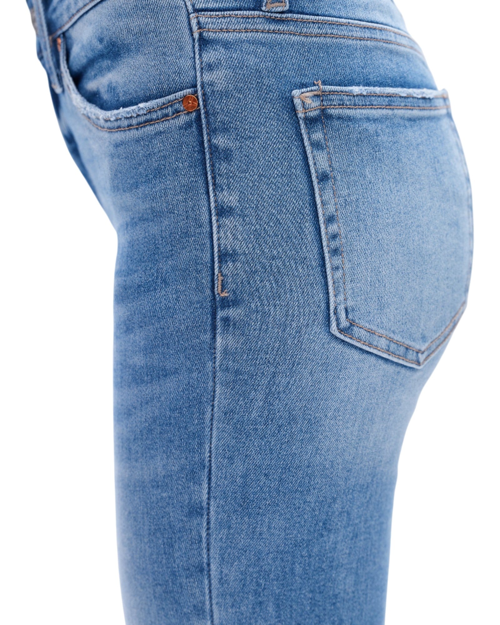 Close-up of blue jeans on a white background.