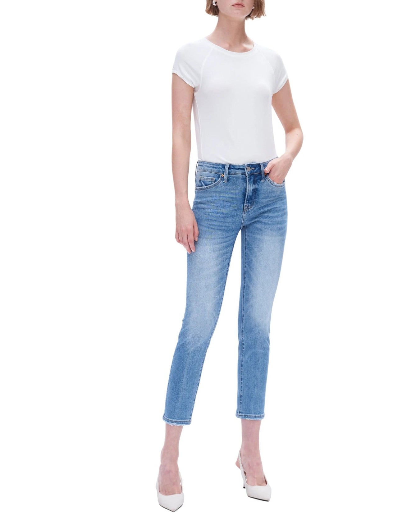 Woman wearing a white t-shirt and light blue jeans on a white background.