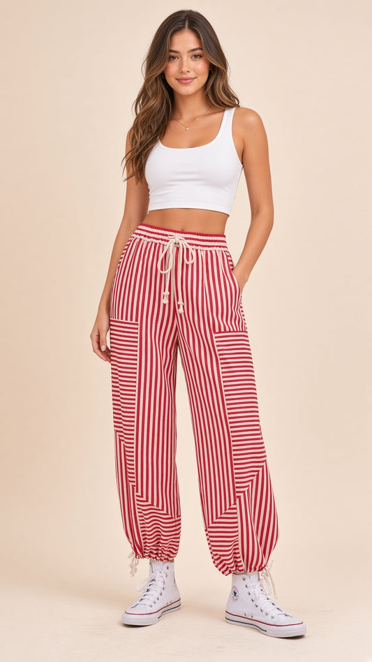 Woman wearing the Game Day Party Pants in red and white stripes.