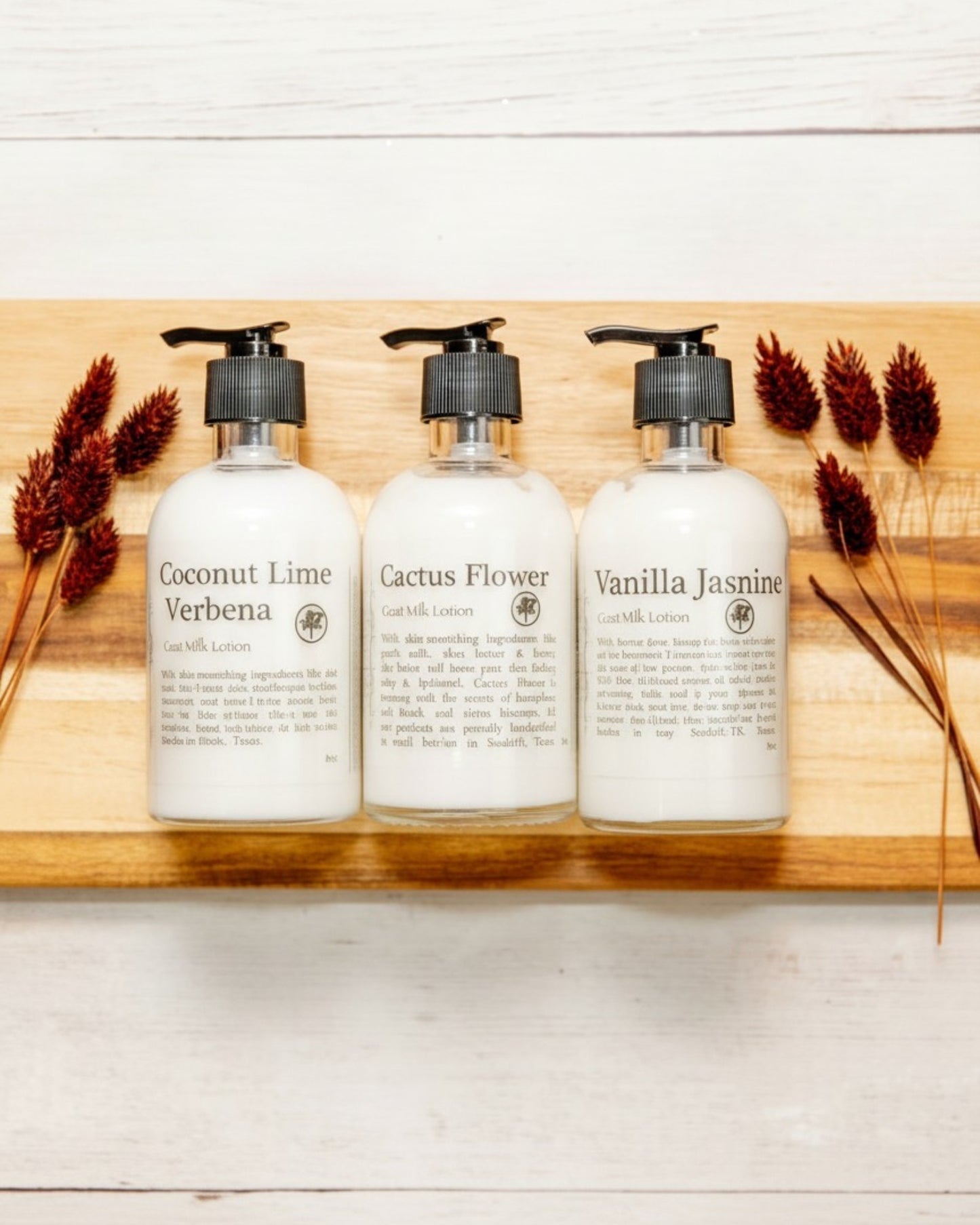 Goat milk lotion in glass bottles on wood background.