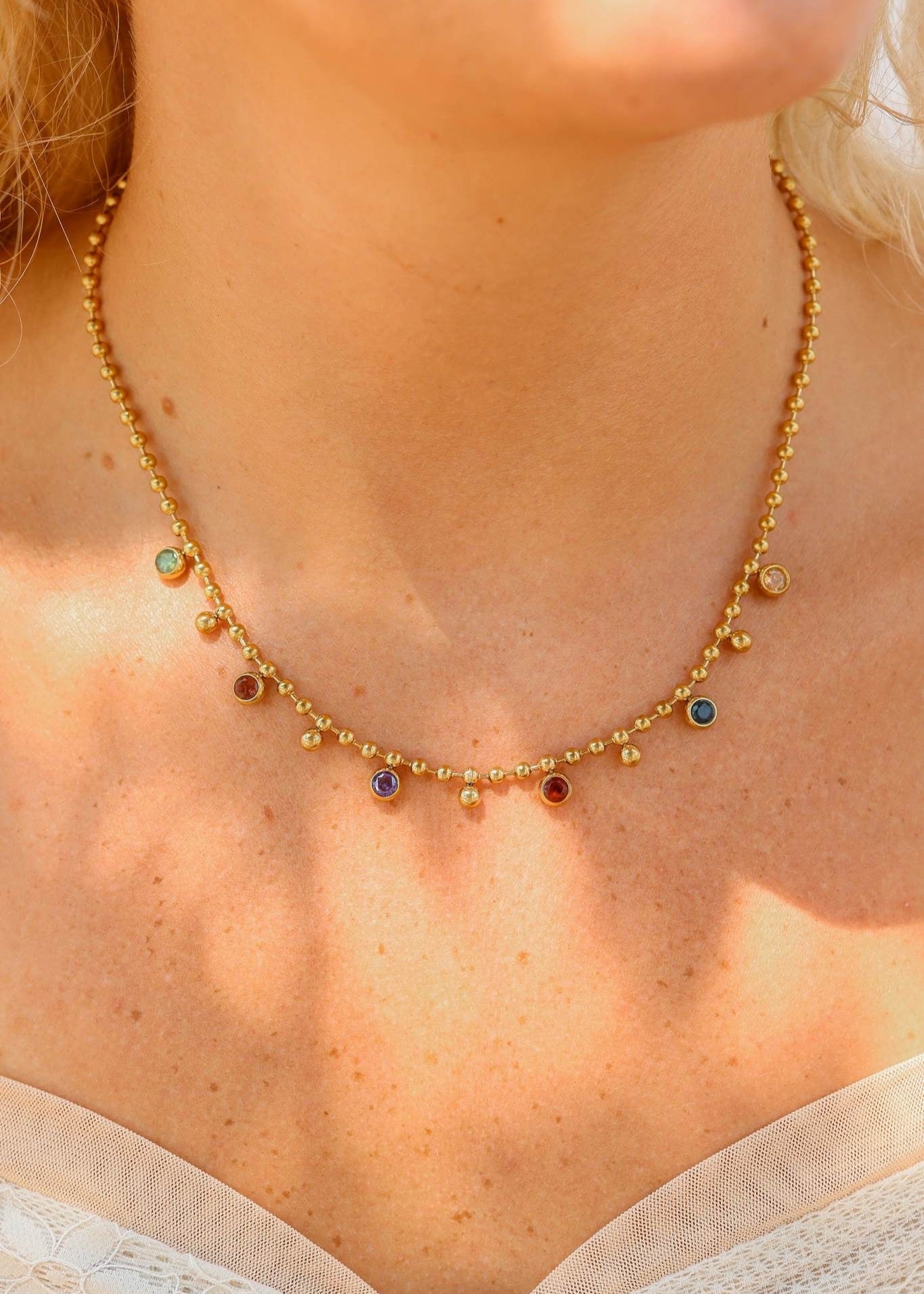 Multicolor beaded gem necklace on gold or stainless chain.