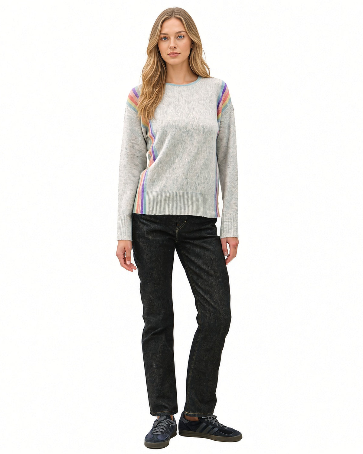 Full-length front view of model wearing grey Rainbow Prism crewneck sweater with rainbow stripes along the shoulders and sides.
