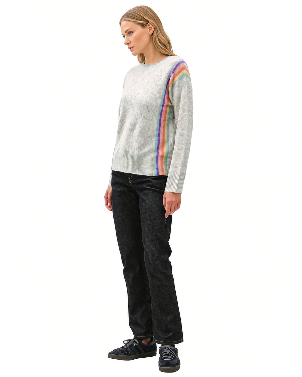 Angled side view of grey Rainbow Prism crewneck sweater showing rainbow stripes from the shoulder to the ribbed hem.