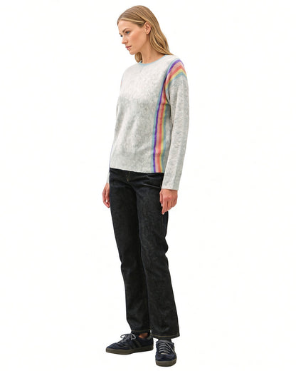 Angled side view of grey Rainbow Prism crewneck sweater showing rainbow stripes from the shoulder to the ribbed hem.