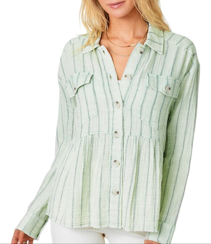 Woman wearing a green striped peplum shirt on a white background.
