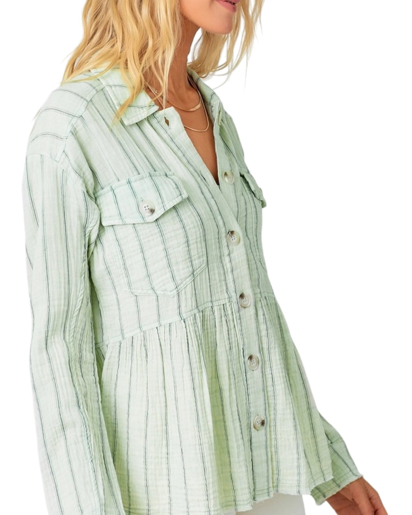 Green striped peplum shirt worn by a person on a white background.