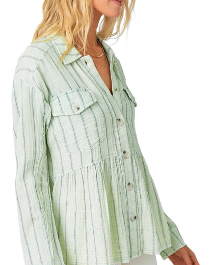 Green striped peplum shirt worn by a person on a white background.