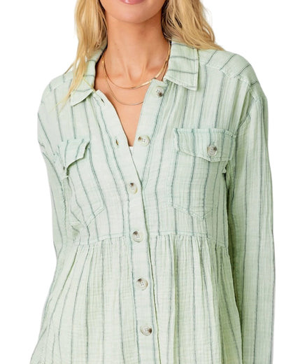 Light green striped peplum shirt worn by a person on a white background.