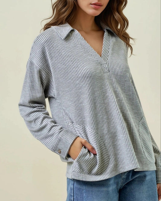 Grey two tone ribbed pullover with collar and rounded pockets. 