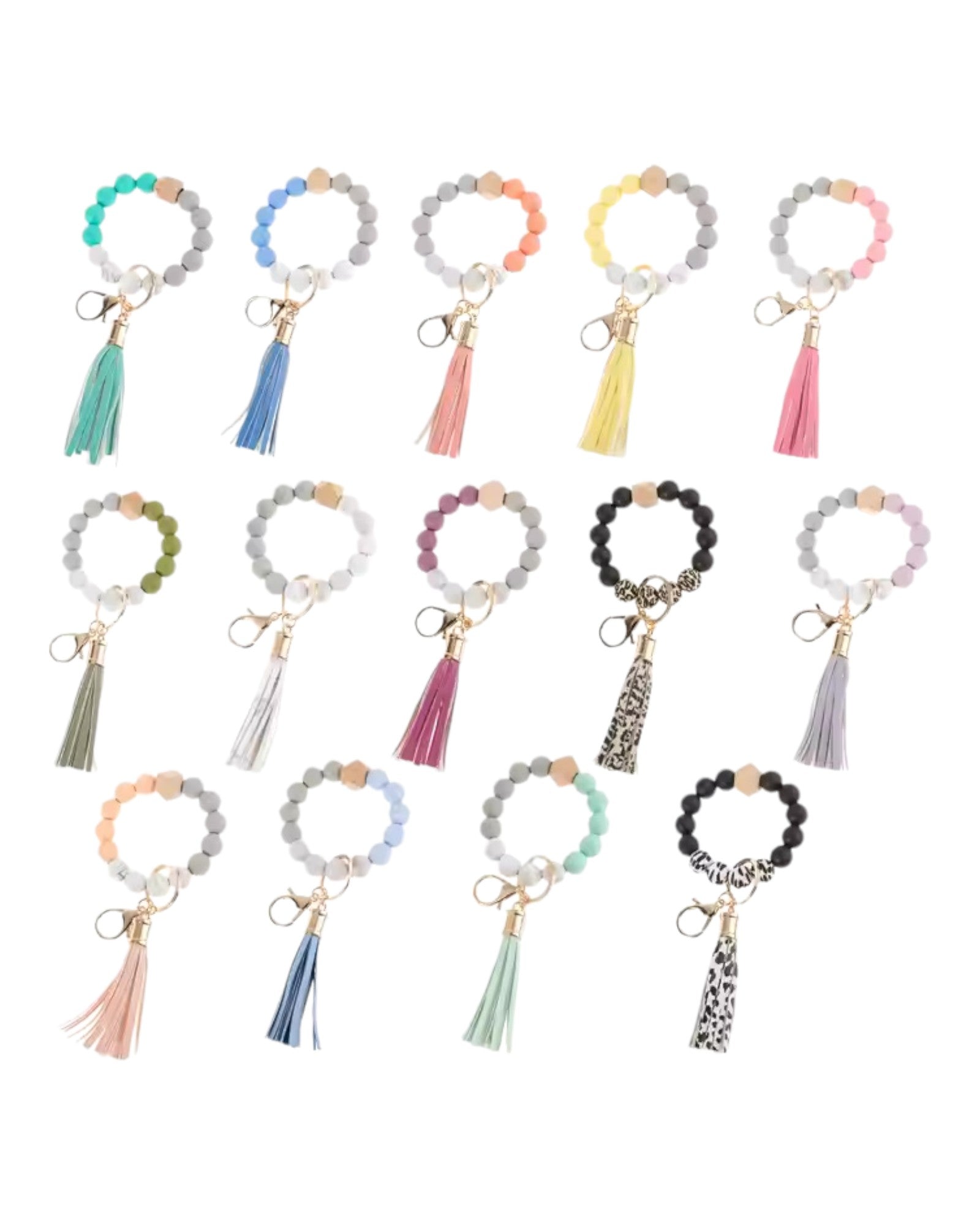 Multiple colors of a silicone and leather tassel boho inspired keychain wristlet / bracelet. 