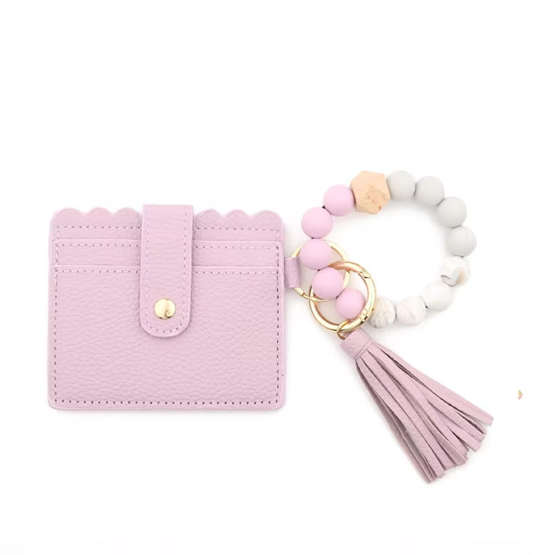 Purple silicone bead bracelet and faux leather wallet with card slots and ID window.  