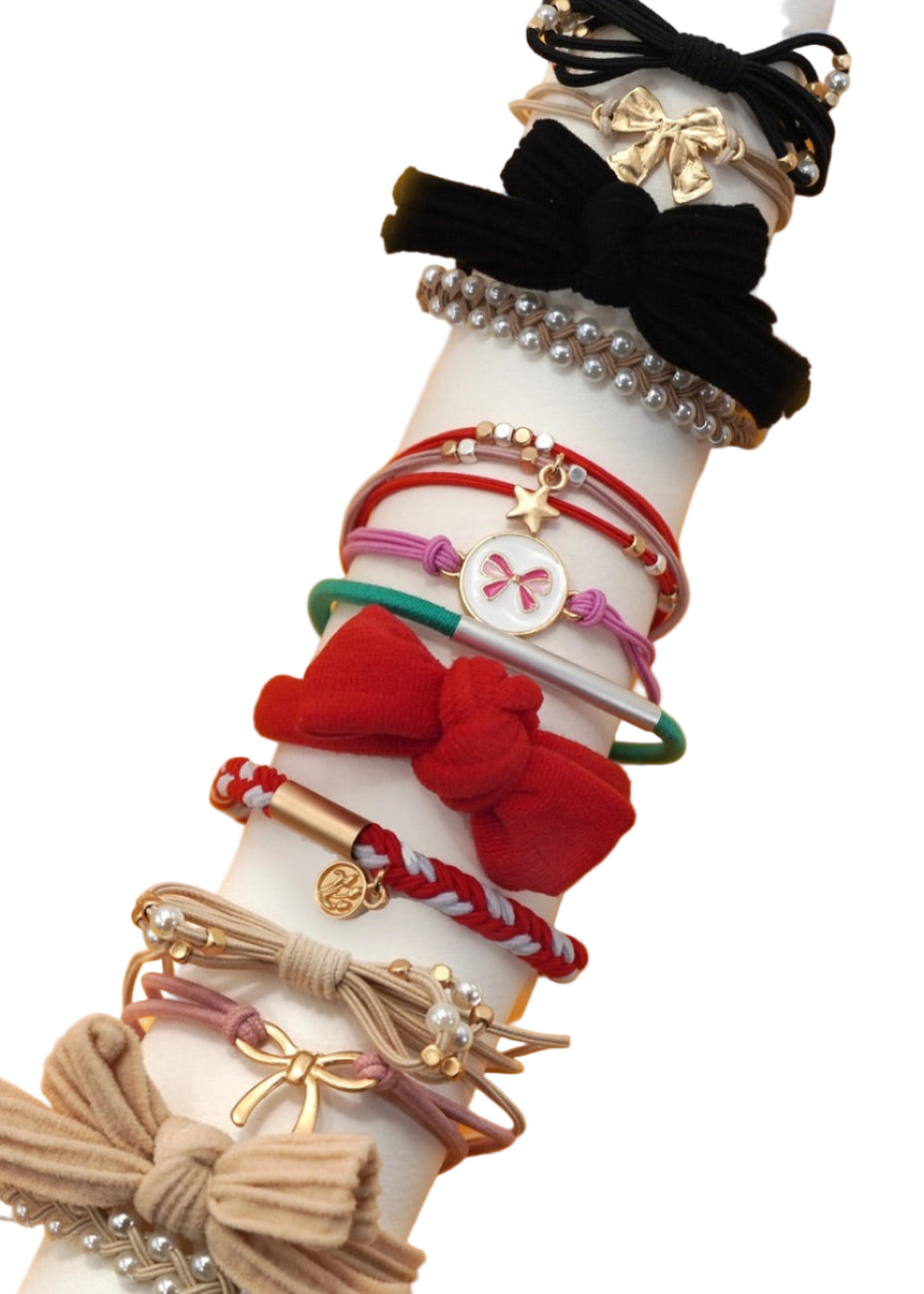 White arm with various colorful hair accessories on a yellow background