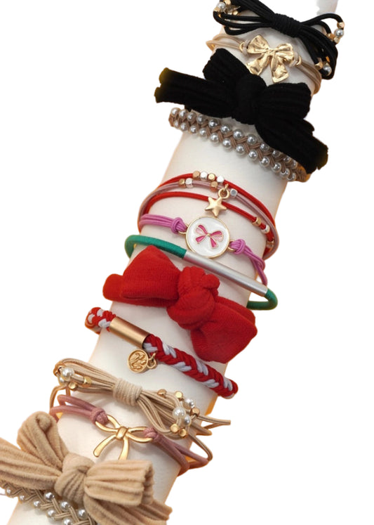 White arm with various colorful hair accessories on a yellow background