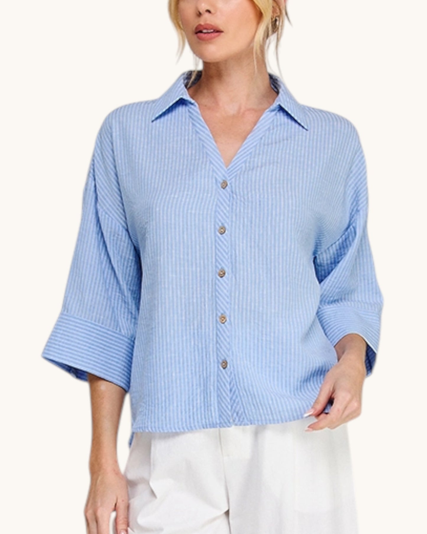 Woman wearing the Hampton Breeze Woven Button Up Shirt with a classic collar and 3/4 length sleeves. Blue and white striped. 